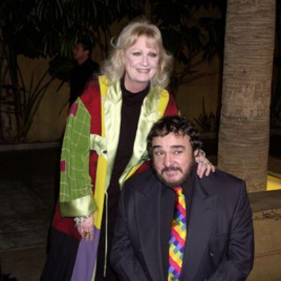 They are posing for cameras as John is kneeling down.